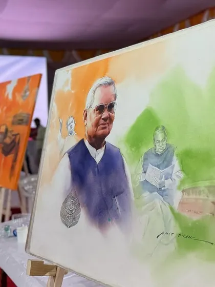 The painting displayed on an easel at the event, alongside works by other artists.