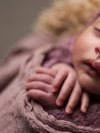 A macro shot focusing entirely on the newborn's tiny fingers, a detail so precious and fleeting.