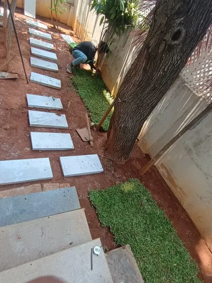 A look at the pathway taking shape, with sections of grass being added along the edges of the stone pavers.