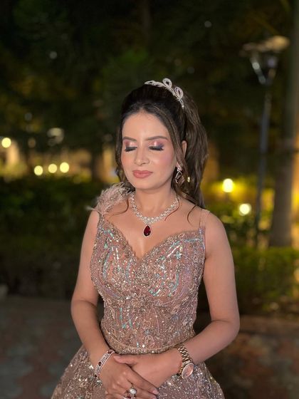 Another angle of this dreamy engagement look. The high ponytail adds a touch of modern glamour, while the feathered details on the gown add a whimsical feel.