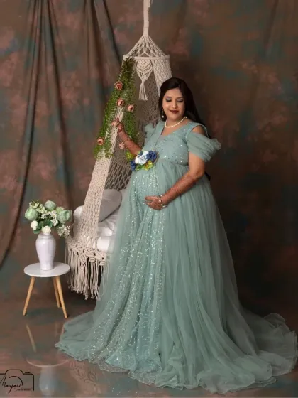 Cradling her bump with a gentle smile, this mama-to-be looks absolutely radiant in our swing setup. The soft textures and colors make for a truly dreamy portrait.