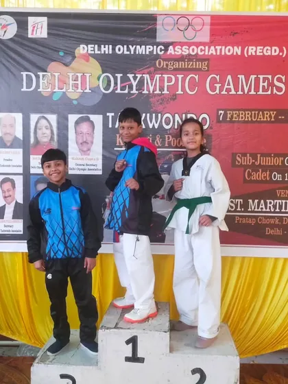 The winners' podium at the Delhi Olympic Games, featuring our talented sub-junior athletes. Their early success is a great motivator for their Taekwondo journey.