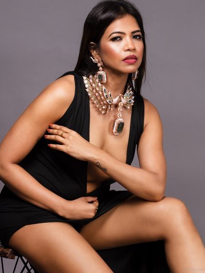 A closer view of the oversized jewellery, highlighting its texture and scale.