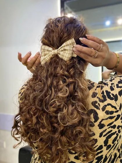 Showing how I place the bow. It's an easy way to style second or third-day hair.