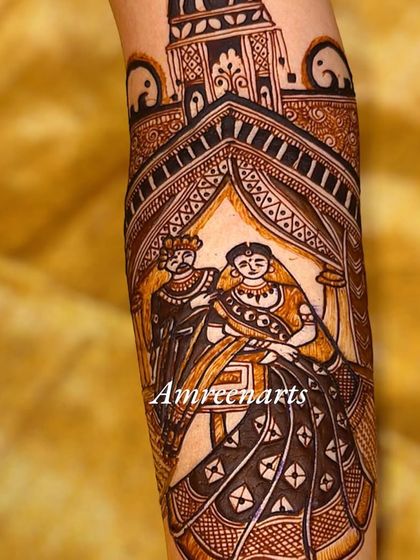 A portrait of a couple within an architectural jharokha frame, adding a regal touch to the design.