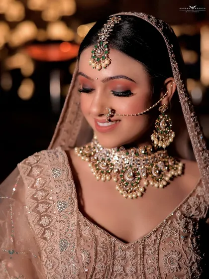 A close-up with the bride's eyes closed, highlighting the subtle and glowing makeup look.