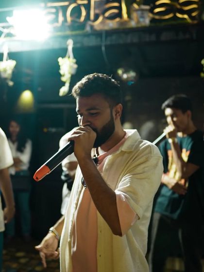 Another artist takes the mic, contributing to the non-stop flow of talent at our Insync Hip Hop Project event. The atmosphere is always electric and full of creative energy.