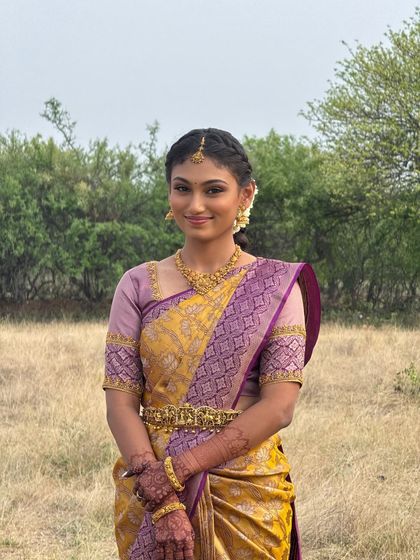 My beautiful bride Priyanka looking serene during her outdoor engagement shoot. Her makeup is kept light and fresh, with a hairstyle that is both elegant and practical for the setting.