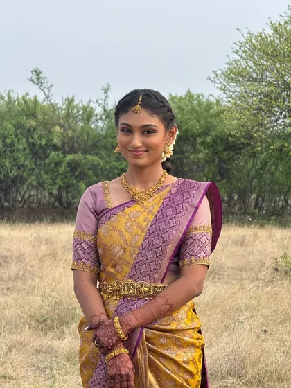 My beautiful bride Priyanka looking serene during her outdoor engagement shoot. Her makeup is kept light and fresh, with a hairstyle that is both elegant and practical for the setting.