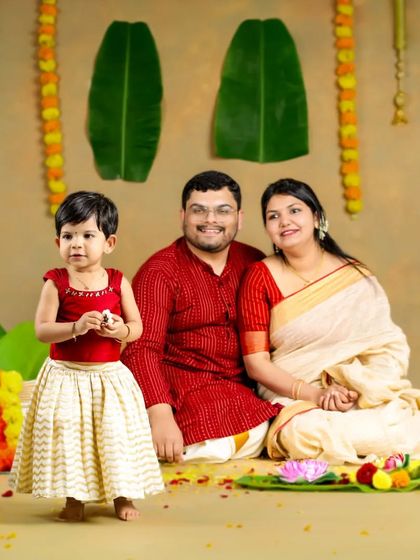 A happy Onam to all! This family looks wonderful in their traditional attire, surrounded by flowers and festive decorations for this special portrait.