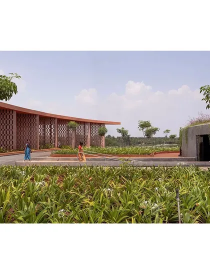 The landscape design incorporates native plants and open pathways, making the entire complex accessible and inviting for the local community to use as a public space.