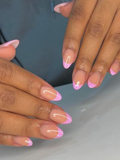 A modern French manicure with a lilac-colored tip. Using color is a great way to update this classic look.