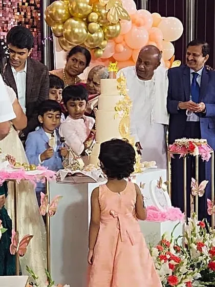 I humbly thank the family of our honorable Ex-Prime Minister, Shri H.D. Devegowda, for the privilege of planning this special day. This moment captures the family celebrating around a magnificent butterfly-themed cake, a testament to the trust placed in us.