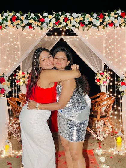 A warm hug with my cousin during our Goa trip. Her silver sequin dress and my red and white outfit show two different ways to dress up for a beach party.