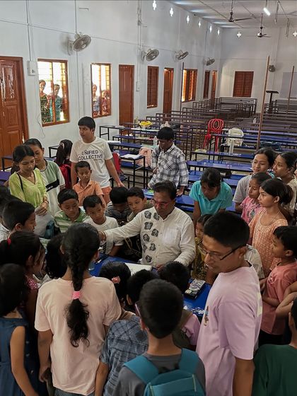 I am surrounded by curious students at the Gogamukh College workshop as I demonstrate a drawing technique. This kind of close interaction is what makes in-person classes so special.