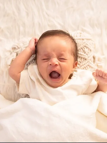A big morning yawn. I capture all the little moments, even the unposed ones, as they show your baby's budding personality.