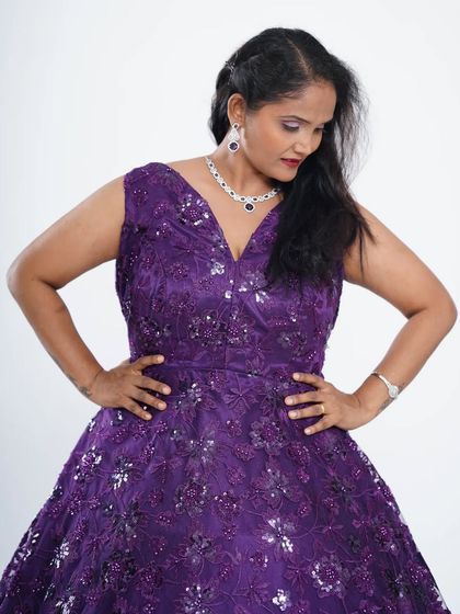 This dark purple gown with intricate stonework is a great option for a birthday, anniversary, or wedding party. The A-line cut is flattering for all body types.