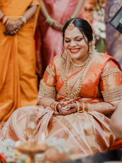 Pure happiness captured in this shot. The bride's smile is the centerpiece, enhanced by a flawless makeup application that looks both natural and elegant.