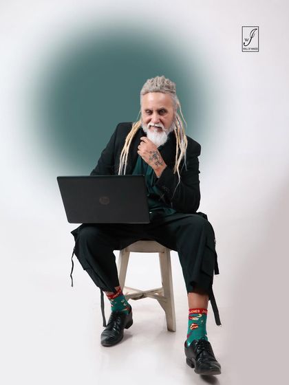 Incorporating a laptop as a prop, this shot blends fashion with a modern, professional narrative.