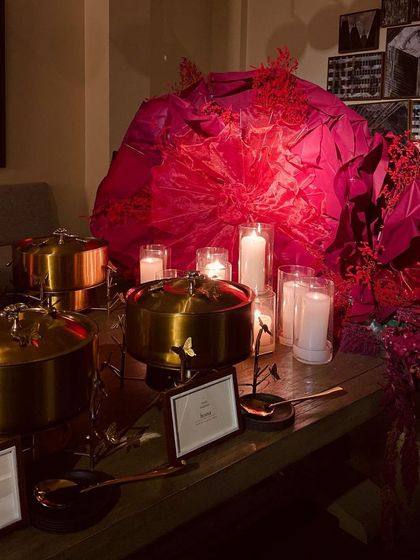 Our stunning gold butterfly chafing dishes used for a client's iconic Diwali party, set against a vibrant, artistic backdrop.