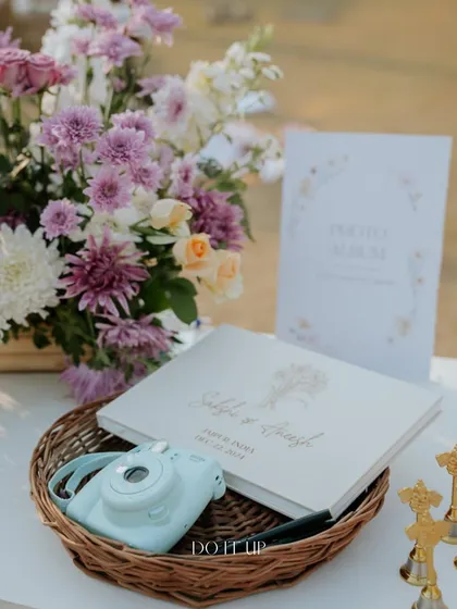 A thoughtful guest book station. I provided a polaroid camera and a custom album for guests to leave photos and messages, creating a cherished keepsake for the couple.