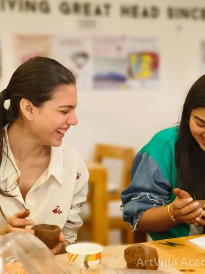 Laughter and creativity go hand in hand at our pottery date workshops. These two are sharing a joyful moment while working with clay, making memories along with their art.