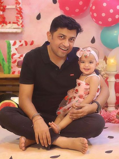 A sweet father-daughter moment during her first birthday cake smash. These are the memories that will be cherished for years to come.