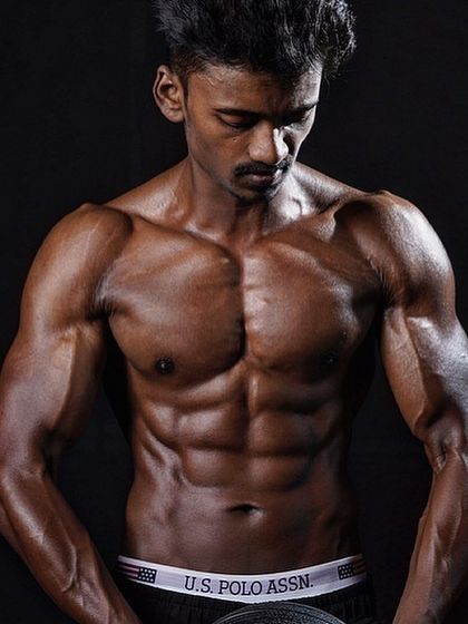 A powerful shot showcasing the results of transforming from obesity to a shredded physique. The focus here is on the defined chest and abdominal muscles.