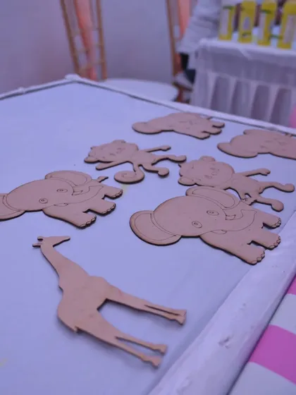 A creative party favor idea! We set up a station where kids could paint their own wooden animal cutouts to take home as a fridge magnet.