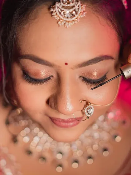 Applying mascara is a final, important step to make the eyes pop. This is a close-up of the technique.
