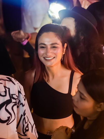 A candid shot of a guest smiling and enjoying the music.