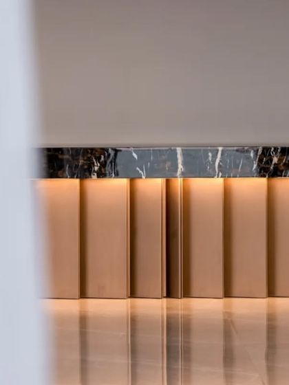 This detail shot of a console in the Mumbai penthouse showcases my belief in subtle luxury. The clean lines of the metallic base, the rich texture of the marble top, and the soft, reflected light create a moment of refined elegance.
