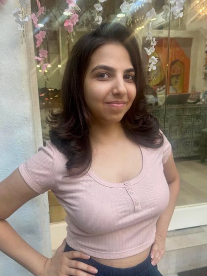 A great haircut can boost your mood. Here is the happy client after her styling session, looking confident with her fresh, bouncy layers.