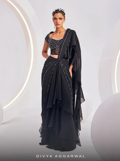 A full-length view of the Nerio Saree Set, highlighting the layered, ruffled hem that adds movement and drama to the look.