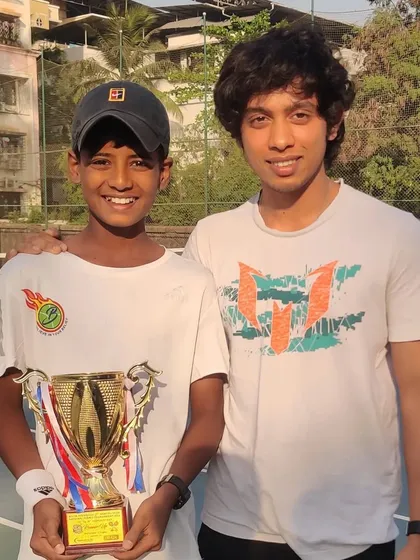 Mentors and friends celebrating a player's success. Rishikesh Mane with his U12 National Runner-Up trophy, a result of teamwork and belief.