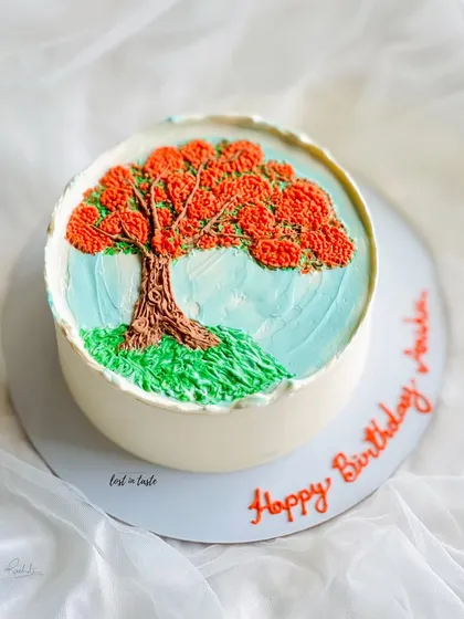 This cake is a tribute to the beautiful Gulmohar tree. The design is hand-piped with colored buttercream to create a miniature painting you can eat.
