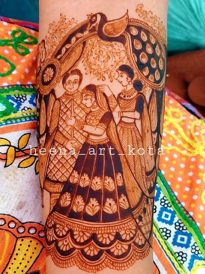 A close-up of a beautiful portrait showing the bride with her mother and father, a cherished moment captured in henna.