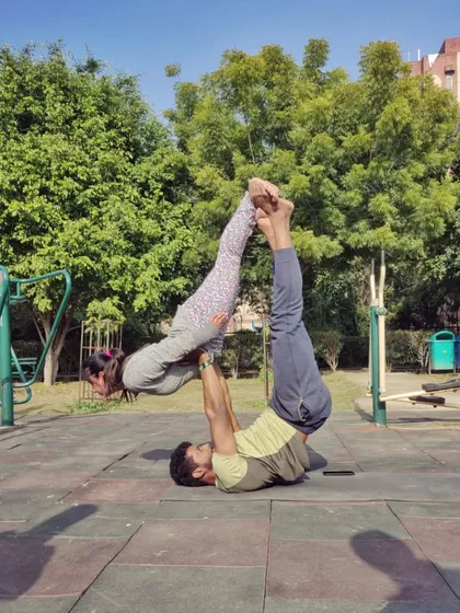 A classic acro yoga "bird" pose. This posture is wonderful for the flyer to open their chest and for the base to build leg strength and stability. It feels like flying.