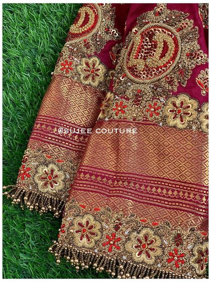 A detailed close-up of the sleeve, highlighting the custom initial embroidery. The combination of the Kanchipuram fabric border and the intricate handwork makes this piece truly special.