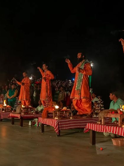 Candid shots of the priests and the large crowd of devotees during the Maha Aarti at JK Temple, capturing the community and shared experience of the event.