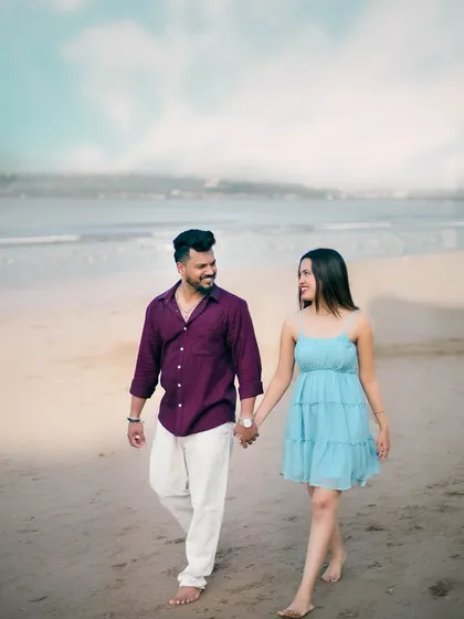 A romantic walk on the beach during a pre-wedding shoot, capturing a natural and candid moment between the couple.
