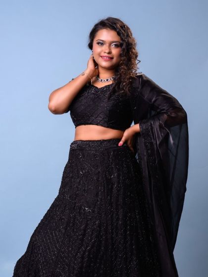 A full-length shot showing how the glamorous makeup and hair complete the entire party look.