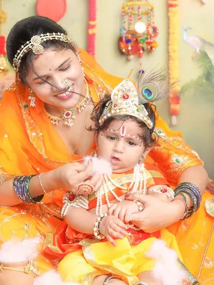 A tender moment, where a mother's love is so clearly visible. The soft cotton 'makhan' adds a fun, textural element to the scene.