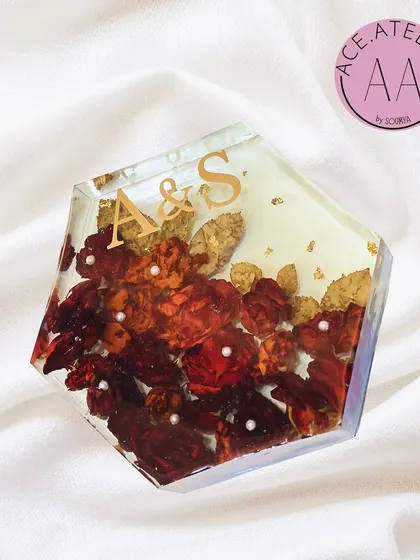 This hexagonal resin block preserves wedding varmala flowers along with the couple's initials. It's a modern and unique way to hold onto a piece of your wedding day.