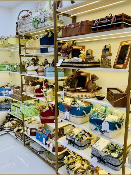 Shelves filled with a wide variety of our handcrafted hampers and gift baskets. This image gives you a sense of the vast range of styles, colors, and sizes we have available to choose from.
