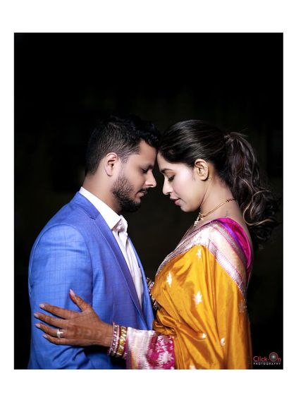 An intimate and artistic couple portrait from an engagement shoot, with a dark background that emphasizes their connection.