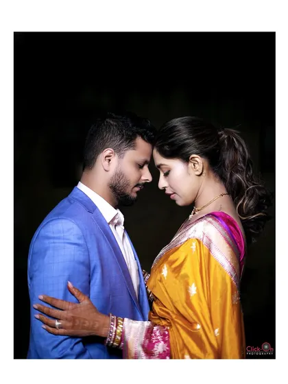 An intimate and artistic couple portrait from an engagement shoot, with a dark background that emphasizes their connection.