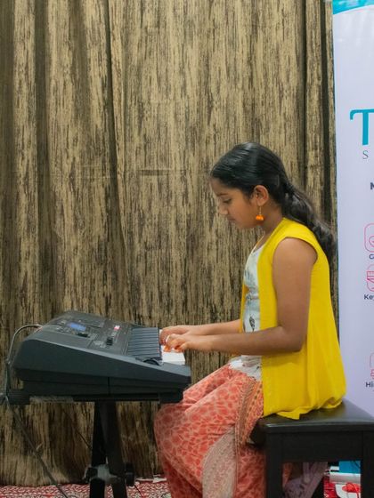 A student performs on the keyboard at our HSR branch open mic. We have active communities at all our locations.