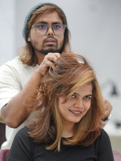 Here I am, styling a client's new copper-colored hair. The warmth of the color is stunning.