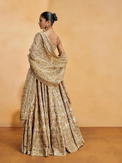 Another angle of the sleek and sculptural bun, a perfect example of high-fashion hairstyling.
